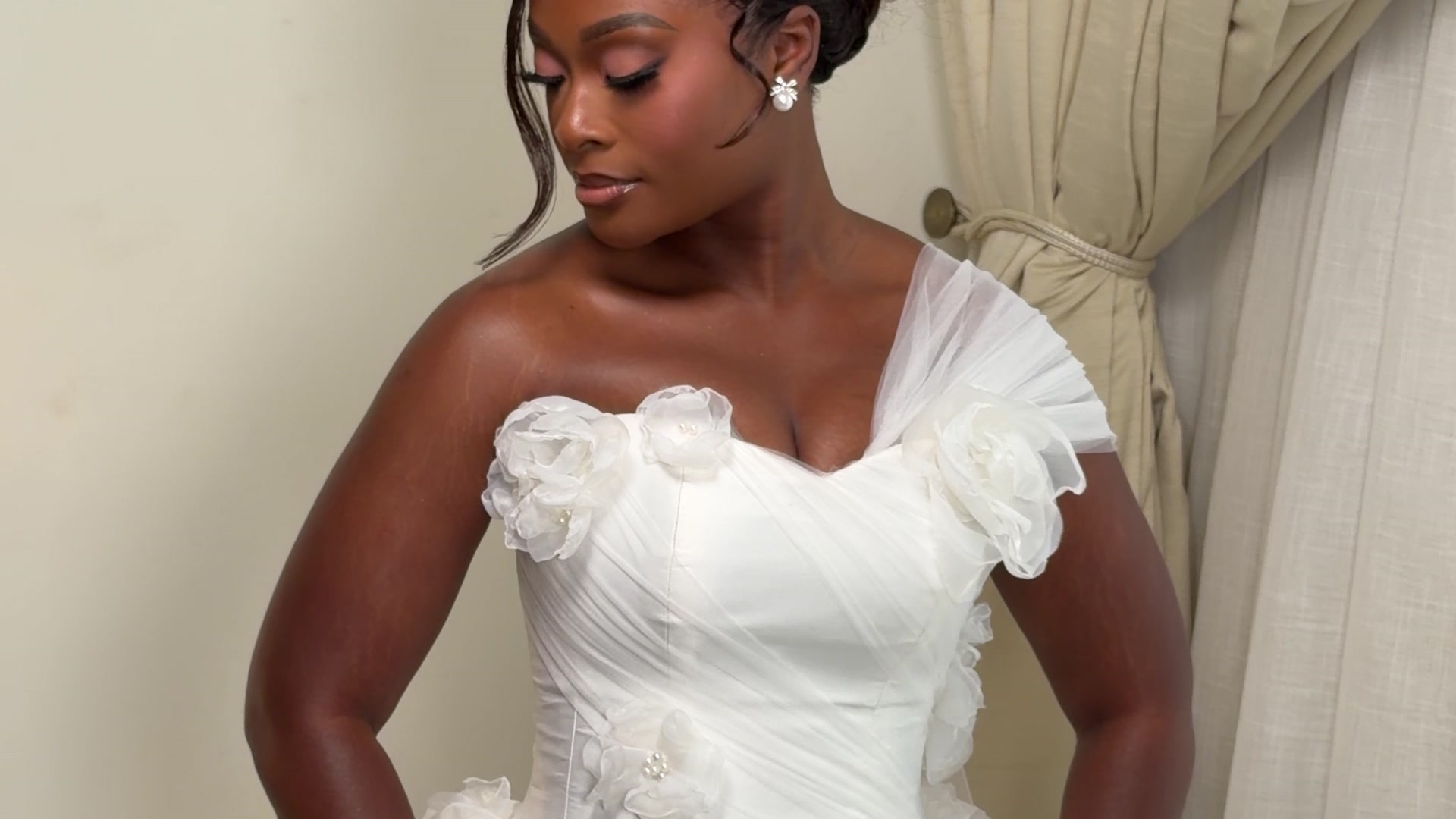 Bridal portrait in white one-shoulder gown with floral appliqués